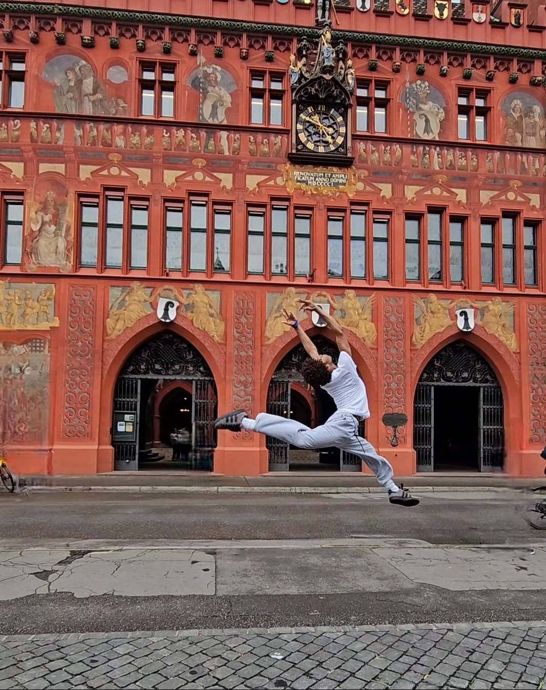 A Brooklyn to Basel exchange dancer jumping in front of Basel Town Hall
