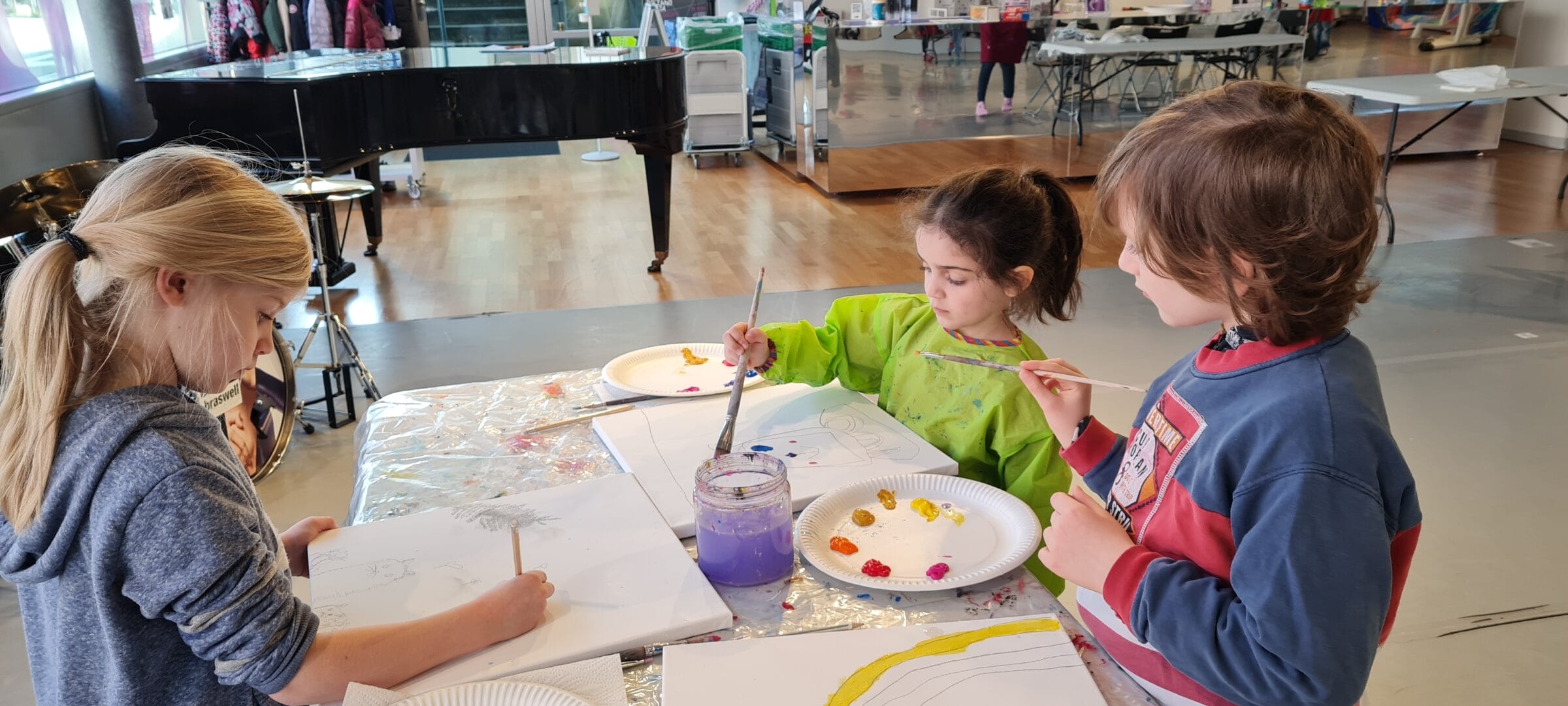 Children sharing a creative painting session at arts camp