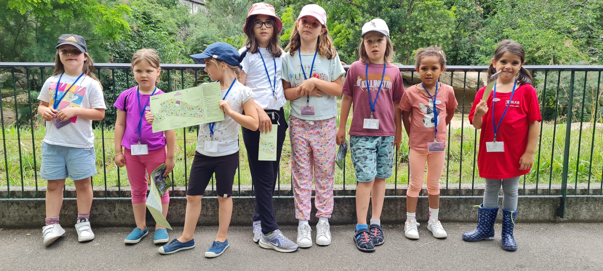 Summer arts campers together outdoors in sun hats